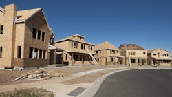 A row of single-family homes under construction A row of single-family homes under construction