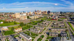 Aerial view of residential neighborhood in Detroit with city skyline in the background