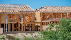 Builders work on new rental housing development