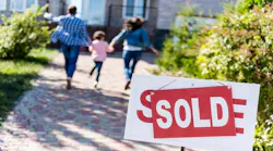 A family runs excitedly toward their recently purchased home.