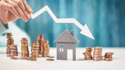 Coins stacked around a model home with an arrow pointing downward indicate decreased home prices. Coins stacked around a model home with an arrow pointing downward indicate decreased home prices.