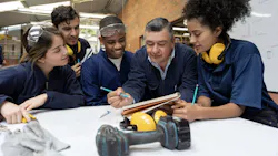 Career and technical education instructor working with a group of students Career and technical education instructor working with a group of students