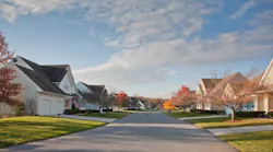 A suburban street of single-family homes in the fall
