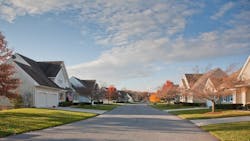 A suburban street of single-family homes in the fall A suburban street of single-family homes in the fall