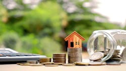 A wooden model house sits on a stack of coins, indicating equity growth. A wooden model house sits on a stack of coins, indicating equity growth.