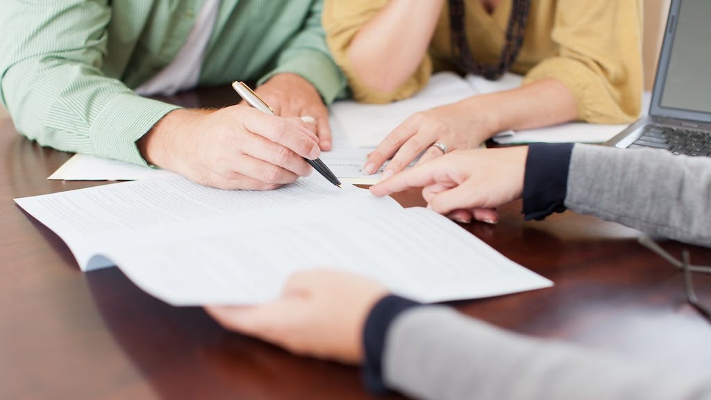 A homebuyer signs a mortgage loan for purchasing their home.
