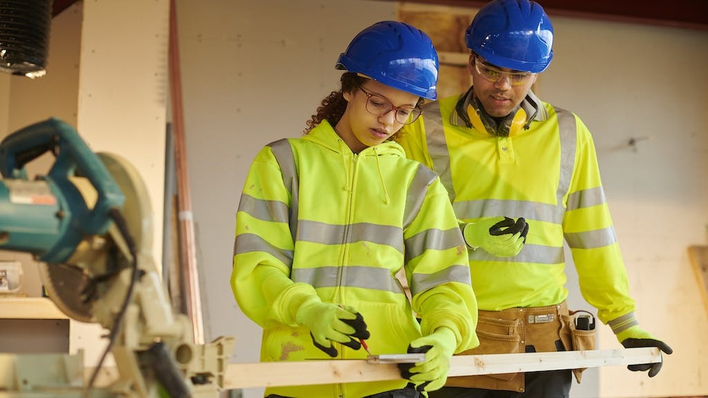 Two trades students working together
