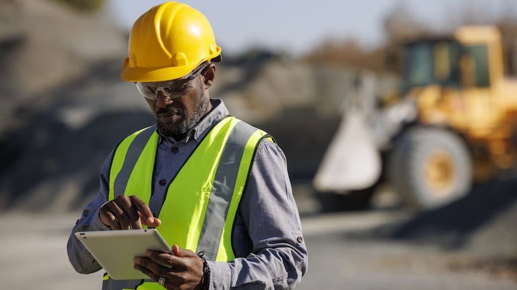 A construction worker using on a tablet