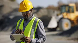 A construction worker using on a tablet