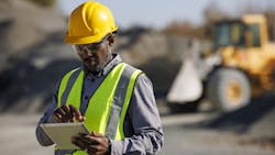 A construction worker using on a tablet A construction worker using on a tablet