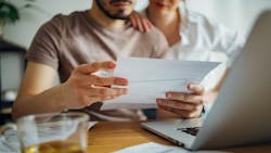 Homeowners appear distressed as they look over their bills Homeowners appear distressed as they look over their bills