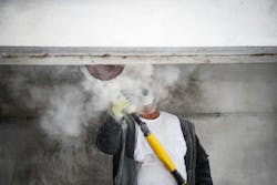 Construction worker creating silica dust by cutting concrete Construction worker creating silica dust by cutting concrete