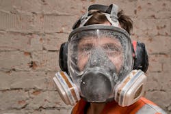 Construction worker wearing respirator as PPE to protect from silica dust exposure Construction worker wearing respirator as PPE to protect from silica dust exposure