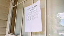 A foreclosure notice taped to the window of a home A foreclosure notice taped to the window of a home