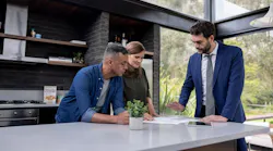 A couple reviews the contract for their home with a real estate agent