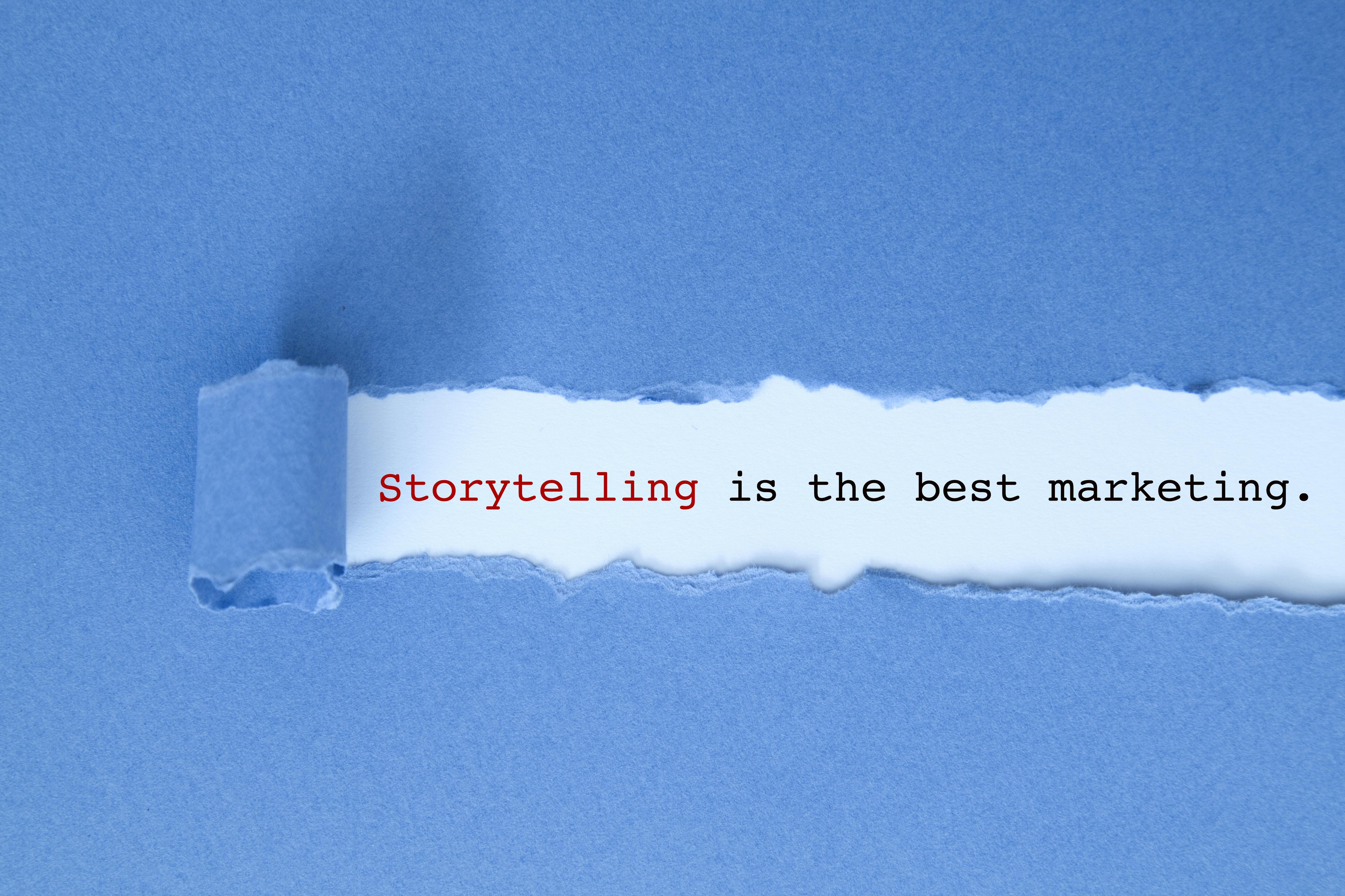 Blue paper strip torn back to reveal words saying: 'Storytelling is the best marketing'