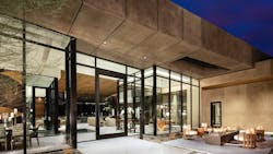 The dramatic entry to The new American Home 2025 with pivoting door and expansive glass window walls The dramatic entry to The new American Home 2025 with pivoting door and expansive glass window walls