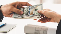 One individual hands money to another individual