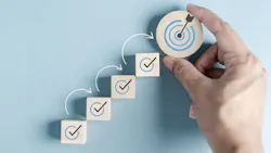 Ascending wood blocks show check-marked steps leading to achieving a business goal Ascending wood blocks show check-marked steps leading to achieving a business goal