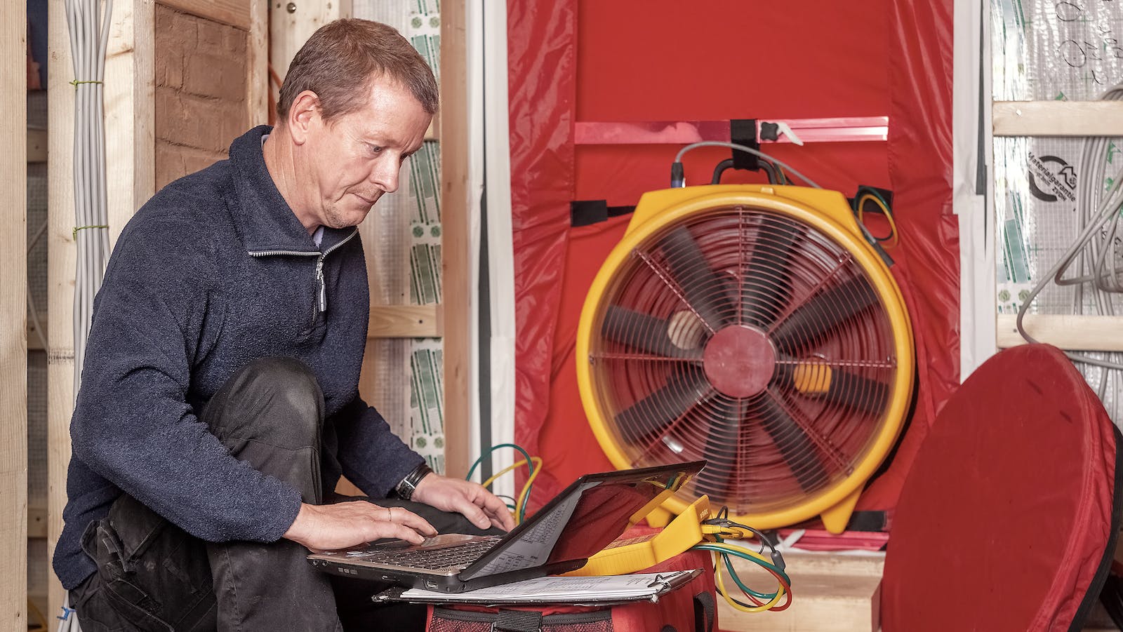 Man doing blower door test on a home
