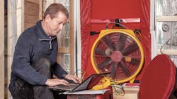 Man doing blower door test on a home Man doing blower door test on a home