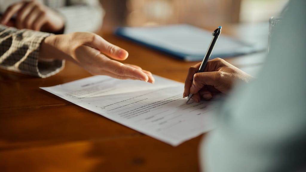 Homebuyer signs mortgage loan application