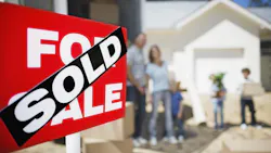A family moves into a home. A sign in the front yard indicates that the home just sold. A family moves into a home. A sign in the front yard indicates that the home just sold.