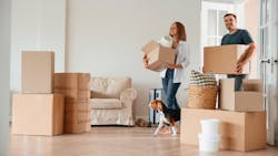 Cardboard boxes line the entry of a home as a family moves in. Cardboard boxes line the entry of a home as a family moves in.