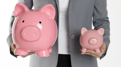 Person holds a large and a smaller piggybank in each hand representing the increase in the amount of a typical down payment for a home