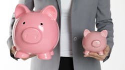 Person holds a large and a smaller piggybank in each hand representing the increase in the amount of a typical down payment for a home Person holds a large and a smaller piggybank in each hand representing the increase in the amount of a typical down payment for a home