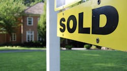 Yellow and black 'Sold' sign in front of an existing home representing the increase in existing home sales prices compared with new-home sales prices Yellow and black 'Sold' sign in front of an existing home representing the increase in existing home sales prices compared with new-home sales prices
