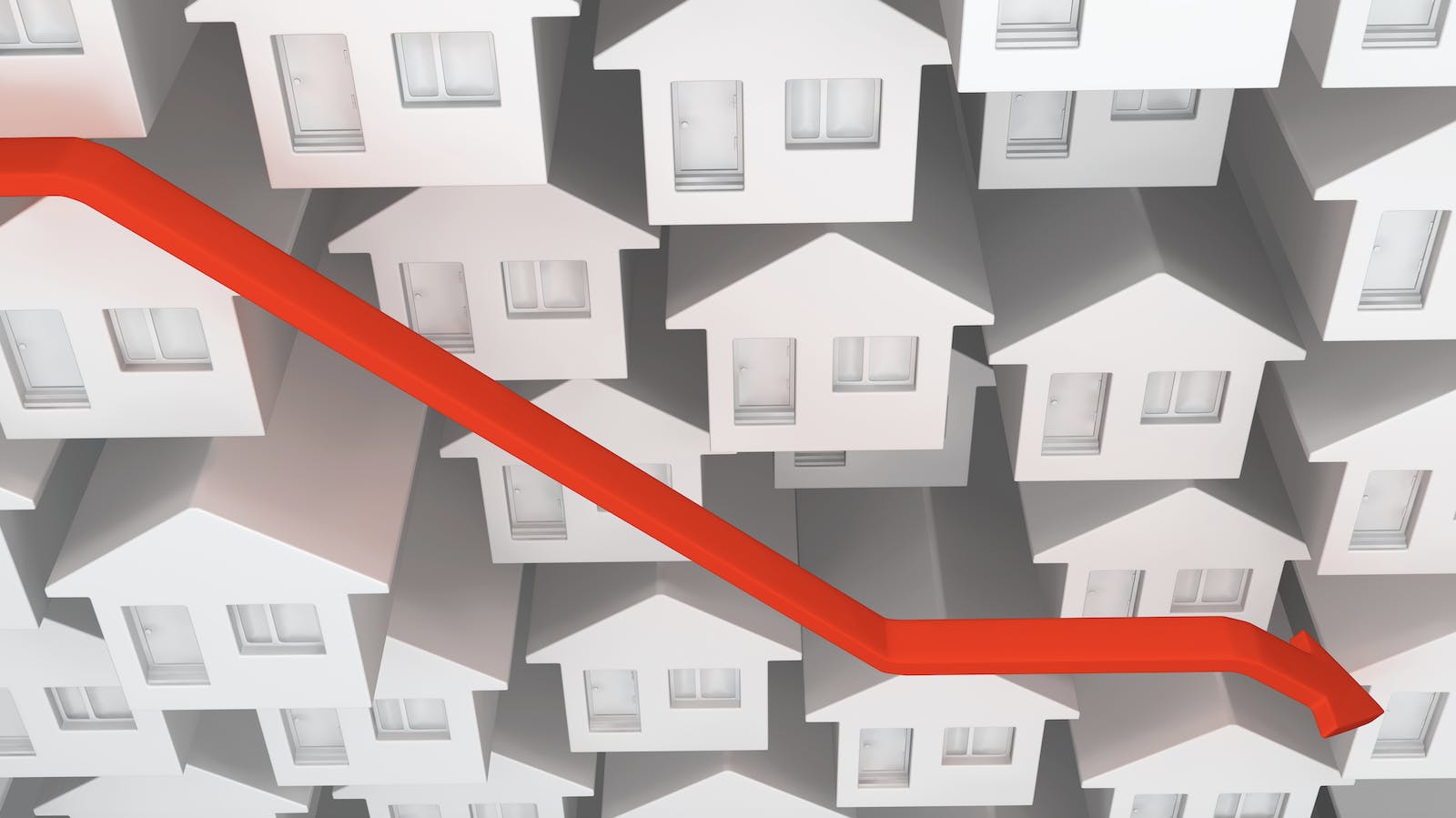 Red downward arrow over backdrop of white and gray houses represents steep drop in new-home sales