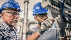 Male apprentice connects wires in a distribution board as part of his training in the skilled trades for home building. Male apprentice connects wires in a distribution board as part of his training in the skilled trades for home building.