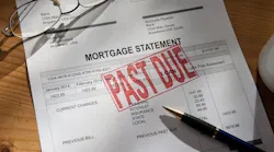 Past-due mortgage statement paperwork with pen and reading glasses on desk