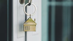 A key with a brass house keyring in the front door of a home represents pending home sales, which declined in January 2025 A key with a brass house keyring in the front door of a home represents pending home sales, which declined in January 2025