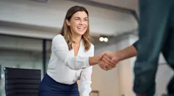 An real estate investor shakes hands with another professional after making a deal