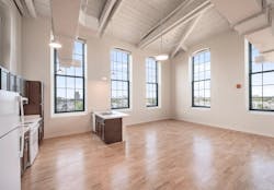 Interior space and kitchen in one of the units at the A & Indiana adaptive reuse project Interior space and kitchen in one of the units at the A & Indiana adaptive reuse project