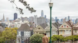 A man looks at the San Francisco skyline, the city with the largest price gap between renting and owning a home