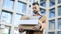 A worker leaves his employment in an office building with a box in hand, representing the layoffs of federal workers by the Trump administration A worker leaves his employment in an office building with a box in hand, representing the layoffs of federal workers by the Trump administration