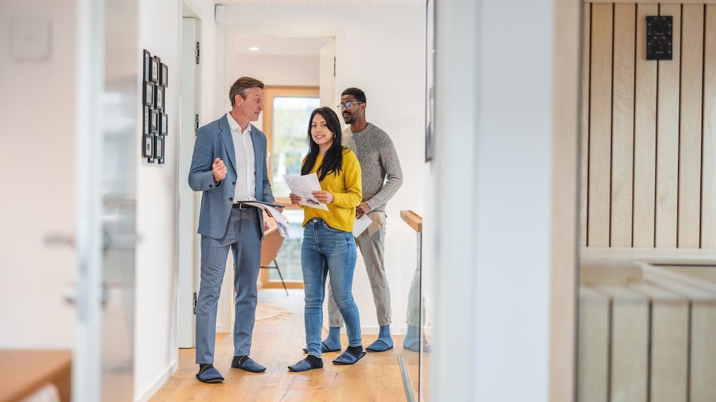 A couple touring a home with a real estate agent