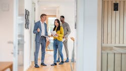 A couple touring a home with a real estate agent A couple touring a home with a real estate agent