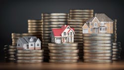 Three home models sit on top of stacks of coins, each representing different levels of home equity Three home models sit on top of stacks of coins, each representing different levels of home equity
