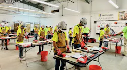 Students at Camp TRF wear hard hats and use construction tools to gain exposure to the skilled trades.