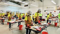 Students at Camp TRF wear hard hats and use construction tools to gain exposure to the skilled trades. Students at Camp TRF wear hard hats and use construction tools to gain exposure to the skilled trades.