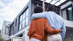 A Black couple looks at their newly purchased home A Black couple looks at their newly purchased home