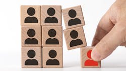Removing a block from a stack of wooden block to represent reshuffling board members Removing a block from a stack of wooden block to represent reshuffling board members