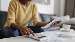 A homeowner goes over her budget on a calculator as homeowner concerns mount about housing affordability. A homeowner goes over her budget on a calculator as homeowner concerns mount about housing affordability.