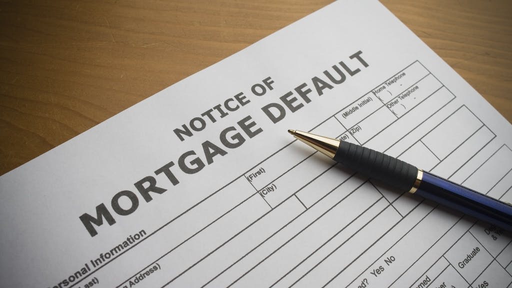 A mortgage default notice on a table as mortgage delinquencies rise.