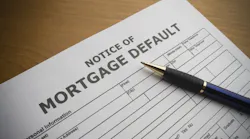 A mortgage default notice on a table as mortgage delinquencies rise.