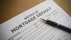 A mortgage default notice on a table as mortgage delinquencies rise. A mortgage default notice on a table as mortgage delinquencies rise.